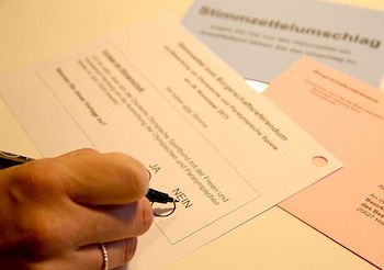 HAMBURG, GERMANY - NOVEMBER 23: A member of the public casts his vote about Hamburg being host of the Olympic Games 2024, the date until the public can vote to be host of the Olympic Games 2024 on November 23, 2015 in Hamburg, Germany. (Photo by Martin Rose/Bongarts/Getty Images)