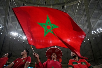 Un hombre flamea una bandera