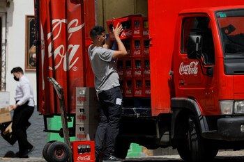 A delivery man unloads crates