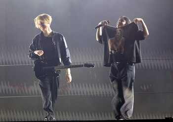 Billie Eilish displays her t-shirt paying tribute to the late Foo Fighters drummer Taylor Hawkins as she and Finneas O'Connell conclude the song "Happier Than Ever" during the 64th Annual Grammy Awards show in Las Vegas, Nevada, U.S., April 3, 2022. REUTERS/Mario Anzuoni