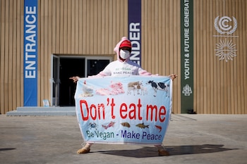 An activist holds a banner,