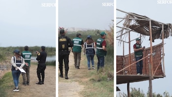 Inspectores con chalecos verdes y un policía caminan por un humedal y una torre de observación de madera