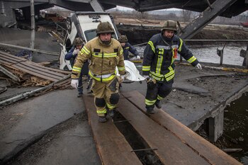 Rescuers carry the body of