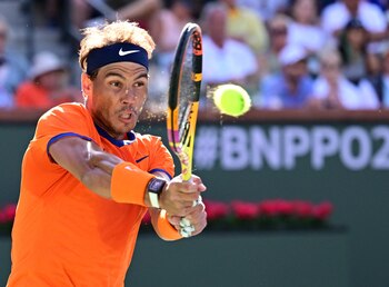 Mar 20, 2022; Indian Wells, CA, USA; Rafael Nadal (ESP) hits a shot during the men’s final against Taylor Fritz (USA) at the BNP Paribas Open at the Indian Wells Tennis Garden. Mandatory Credit: Jayne Kamin-Oncea-USA TODAY Sports