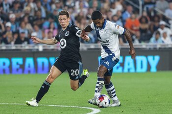 Jul 23, 2023; Saint Paul, MN, USA; Puebla defender Brayan Alexis Angulo Leon (26) controls the ball while Minnesota United midfielder Will Trapp (20) defends during the second half at Allianz Field. Mandatory Credit: Matt Krohn-USA TODAY Sports