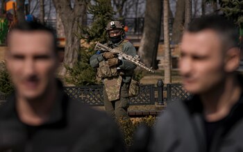 A Ukrainian serviceman guards the