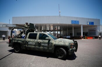 Soldiers patrol in front of