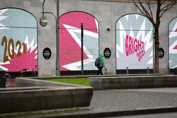 A pedestrian passes the closed