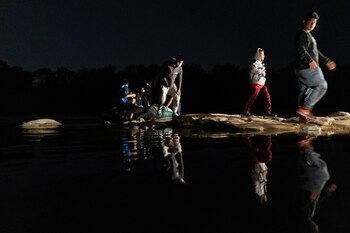 Asylum-seeking migrant families disembark from