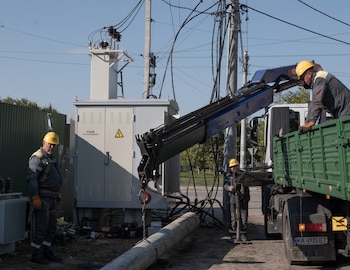 Workers replace an old transformer with a new one in Hostomel, Kyiv region, Ukraine, Sept. 28, 2026. Moscow is not winning on the battlefield. Instead, it is seizing an opening to inflict immense human suffering in Ukrainian cities. (Jędrzej Nowicki/The New York Times)