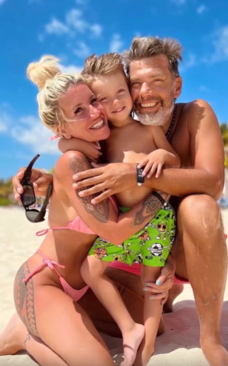 Florencia abrazando a su hijo Felipe junto a su pareja Ramiro Ponce de León en la arena durante una jornada familiar en la playa