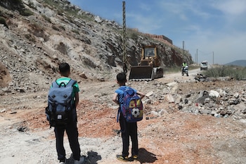 Un bulldozer llena un cráter
