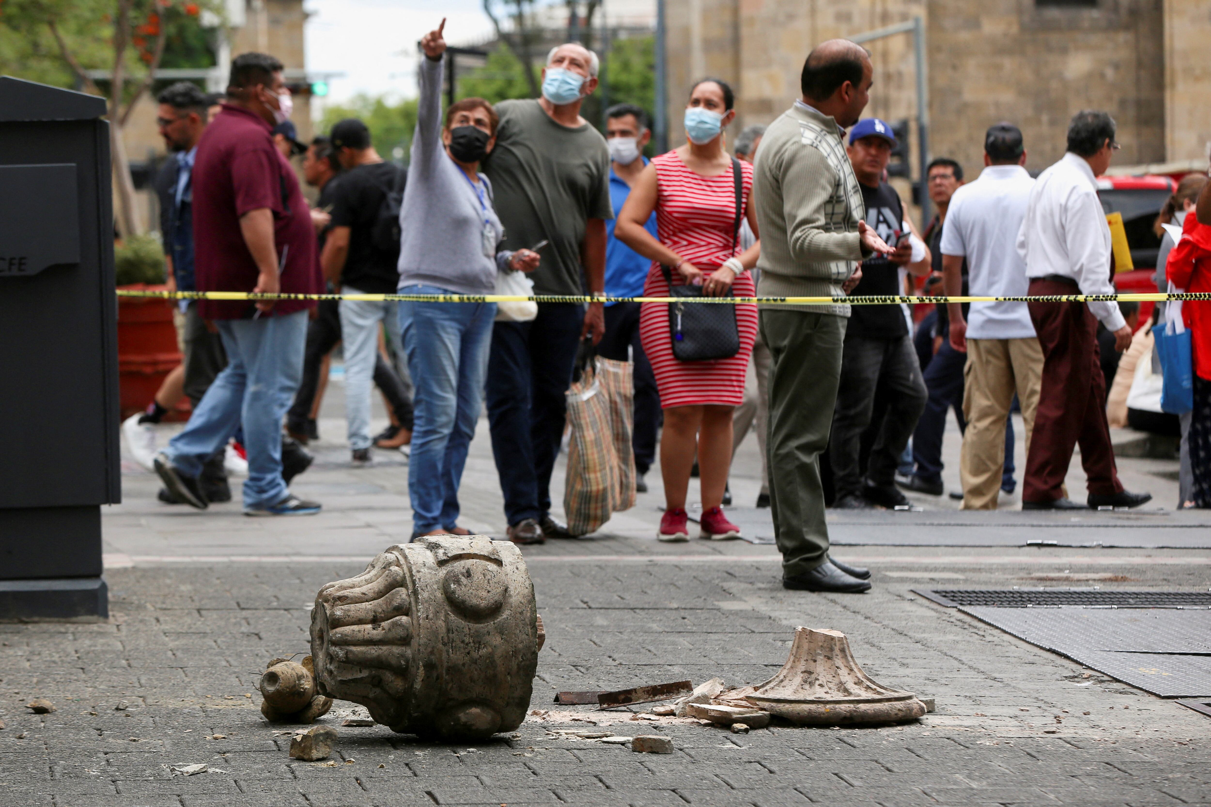 People gesture at an area cordoned off by police after an ornament fell off from a church during an earthquake, in Guadalajara, Mexico September 19, 2022. REUTERS/Fernando Carranza