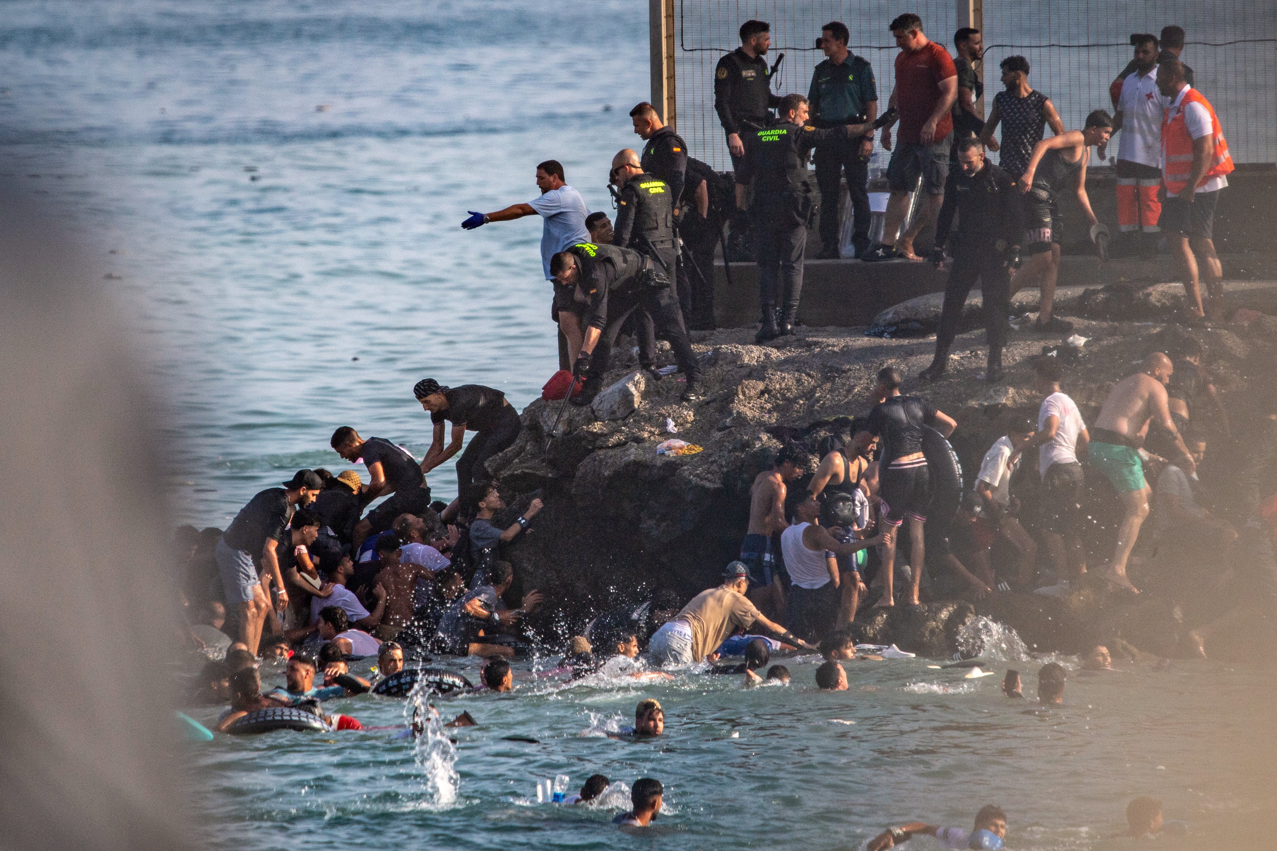 Migrantes intentan cruzar de Marruecos a Ceuta el 30 de julio. (AP Foto/Antonio Sempere)