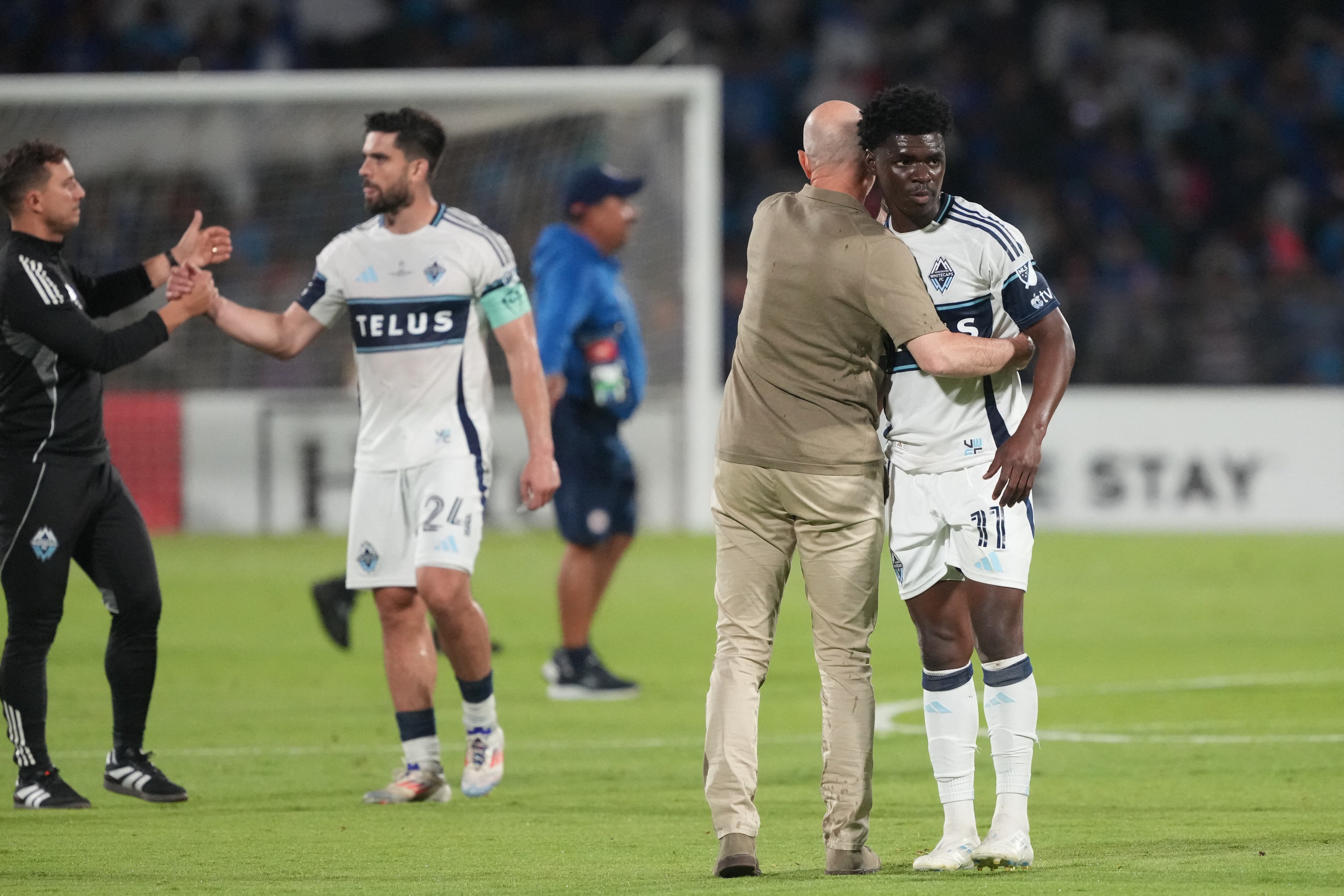 Jun 1, 2025; Mexico City, MEX; Vancouver Whitecaps FC head coach Jesper Sorensen hugs forward Emmanuel Sabbi (11) after the match against Cruz Azul during the final of the Concacaf Champions Cup at Estadio Olímpico Universitario. Mandatory Credit: Kirby Lee-Imagn Images
