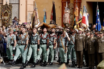 Imágenes de los legionarios portando al Cristo de Mena, en Málaga, el Jueves Santo. Álex Zea / Europa Press.