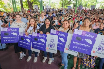 Una beneficiaria muestra una Tarjeta Violeta durante una jornada del programa en Guerrero, iniciativa estatal dirigida a apoyar a madres jefas de familia y mujeres en situación de vulnerabilidad