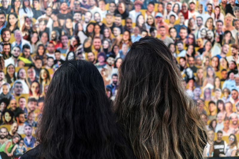 Foto de mujeres israelíes mirando las fotos de las víctimas de los ataques de Hamas del 7 de octubre de 2023, en Reim. REUTERS/Nir Elias/