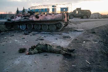 SENSITIVE MATERIAL. THIS IMAGE MAY OFFEND OR DISTURB The body of a soldier, without insignia, who the Ukrainian military claim is a Russian army serviceman killed in fighting, lies on a road outside the city of Kharkiv, Ukraine February 24, 2022. REUTERS/Maksim Levin