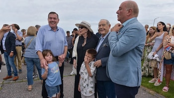 Grupo de personas al aire libre, con hombres, mujeres y niños. El empresario Gustavo Sofovich sonríe en el centro, junto a un hombre, una mujer y dos niños