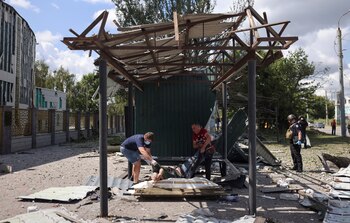 Hombres cargan el cuerpo de