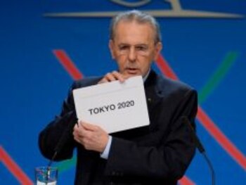 IOC President Jacques Rogge shows