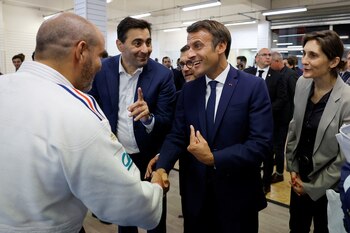 French President Emmanuel Macron shakes