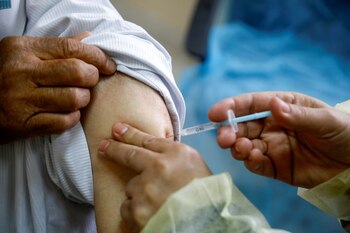 A man receives AstraZeneca vaccine