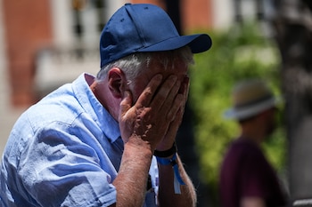 Foto de archivo de un hombre protegiéndose del calor por las calles de Sevilla, a de mayo de 2026 (María José López / Europa Press)