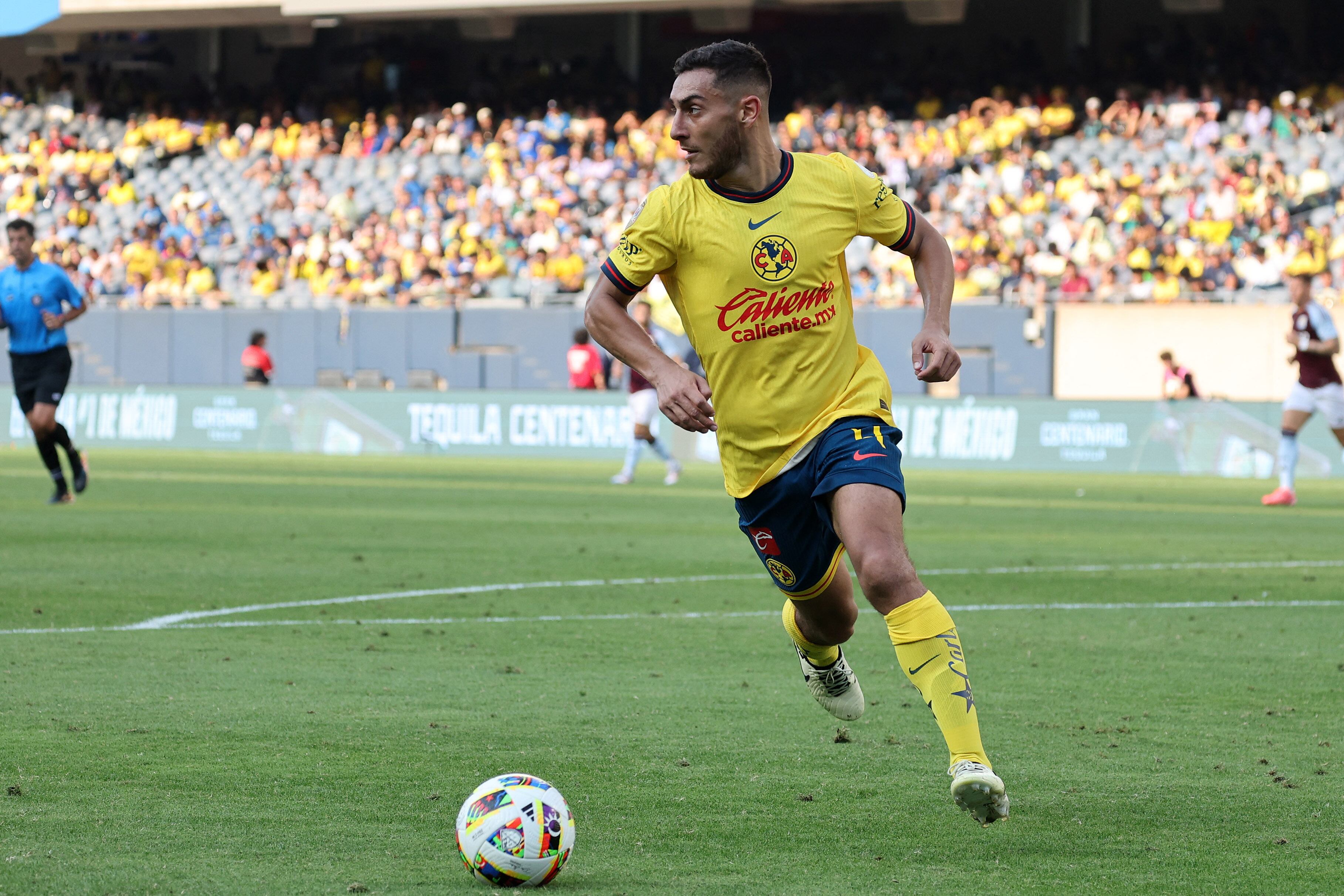 Aug 3, 2024; Chicago, Illinois, USA; Club America defender Sebastian Caceres (4) kicks the ball against  Aston Villa during the second half at Soldier Field. Mandatory Credit: Mike Dinovo-USA TODAY Sports