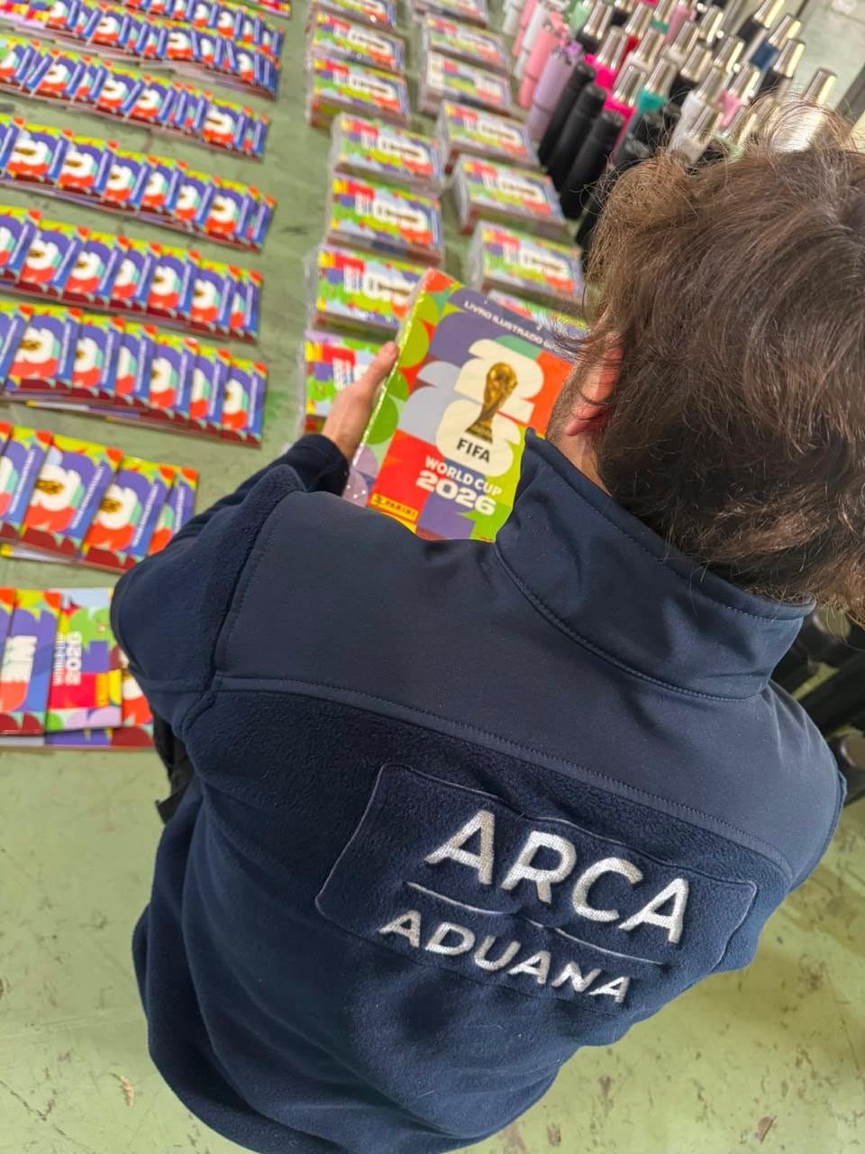 Un trabajador de ARCA Aduana examina un álbum de figuritas trucho de la Copa Mundial FIFA 2026