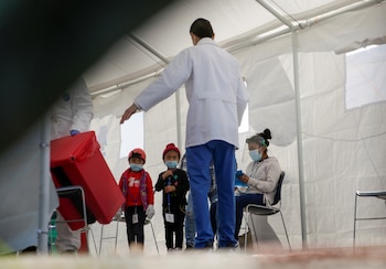 Migrantes, bajo el programa de Protocolos de Protección al Migrante (MPP), esperan en una carpa donde están siendo examinados por la enfermedad del coronavirus (Foto: Reuters)