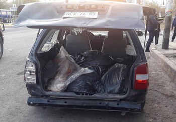 SENSITIVE MATERIAL. THIS IMAGE MAY OFFEND OR DISTURB Bags containing human remains are stacked inside a car after the severed heads of six men were discovered atop the car, as police secures the crime scene, in Chilapa, Mexico March 31, 2022. REUTERS/Stringer NO RESALES. NO ARCHIVES