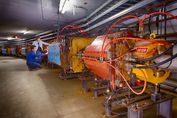 A photo provided by Fermilab shows an inspection of the Muon g-2 ring at Fermilab's new campus in Batavia, Ill., in 2013. Evidence is mounting that a tiny subatomic particle called a muon is disobeying the laws of physics as we thought we knew them, scientists announced on Wednesday, April 7, 2021. (Reider Hahn/Fermilab/U.S. Department of Energy via The New York Times) -- EDITORIAL USE ONLY --