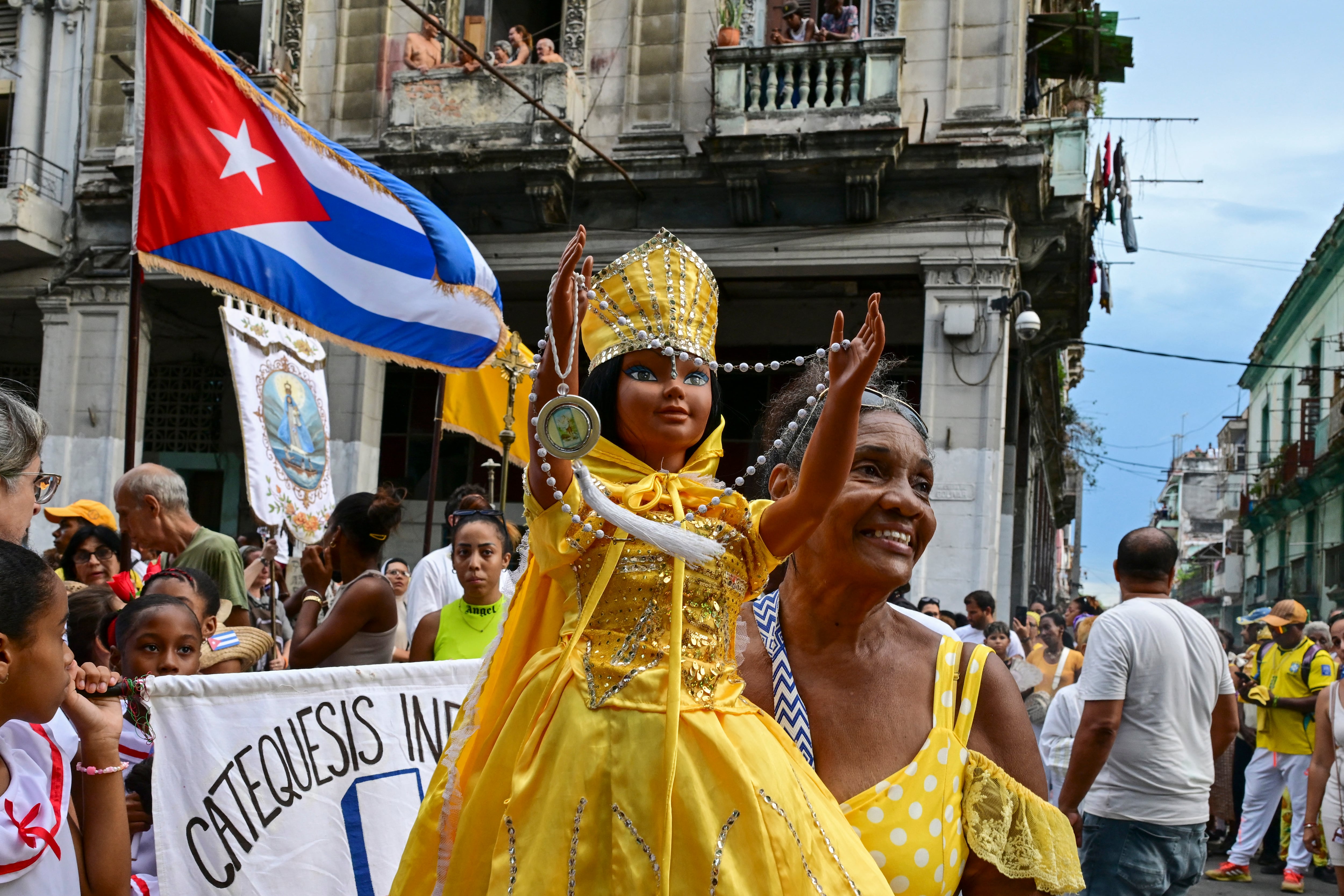 A follower of the Virgin of Charity, Oxun in the Yoruba religion, carries a doll as she takes part in a procession during the Oxun Day celebrations in Havana on September 8, 2026. (Photo by YAMIL LAGE / AFP)