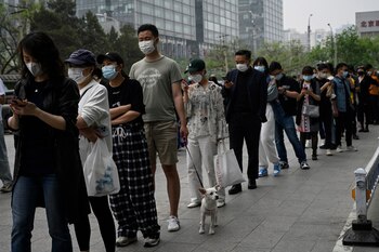 People wait in line to