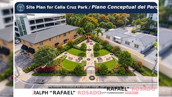 Plano digital de un parque con áreas verdes, bancos, notas musicales en el suelo, una escultura central y edificios residenciales alrededor