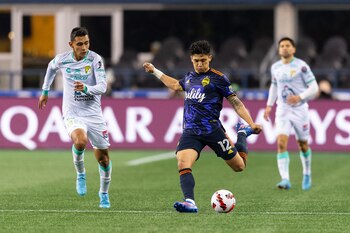 Mar 8, 2022; Seattle, Washington, USA; Seattle Sounders forward Fredy Montero (12) passes the ball while being chased by León midfielder Jose Ramírez (28) during the second half at Lumen Field. Seattle defeated Leon 3-0. Mandatory Credit: Steven Bisig-USA TODAY Sports
