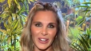 Primer plano de Ivana Icardi sonriendo frente a un fondo decorado con plantas tropicales