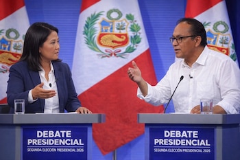 Dos candidatos, Keiko Fujimori y Roberto Sánchez, debaten detrás de podios azules con el texto 'DEBATE PRESIDENCIAL'. Banderas peruanas con escudos adornan el fondo.