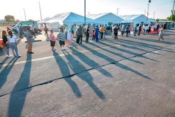 Personas hacen fila para recibir