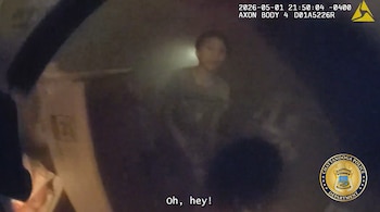 Imagen borrosa de cámara corporal mostrando a una persona pequeña en medio de humo, con una mano en primer plano y el logo de la policía de Chattanooga