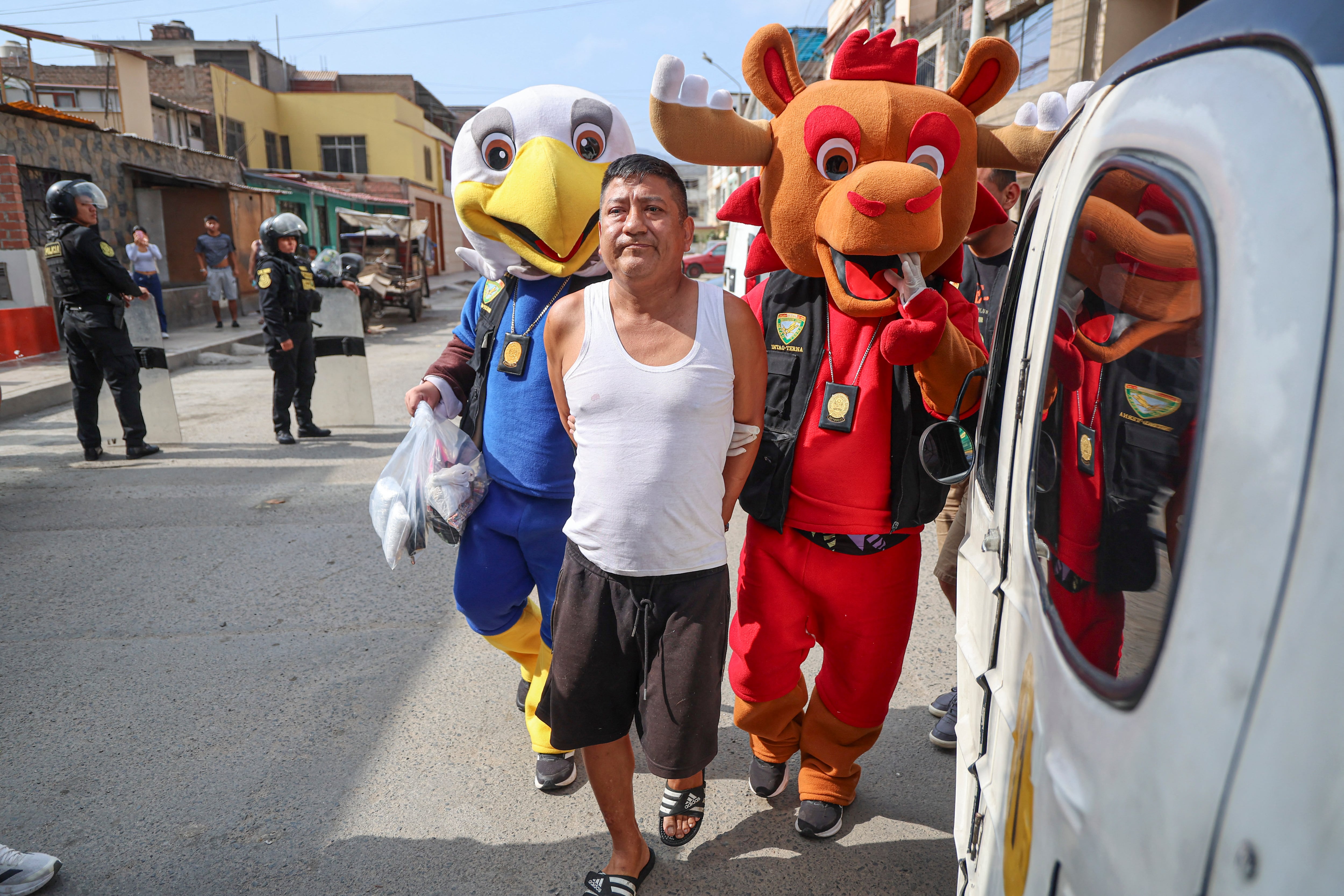 Agentes de la Policía de Perú, disfrazados de mascotas del Mundial 2026, detienen a un hombre en San Juan de Lurigancho por presunto narcotráfico. (AFP)