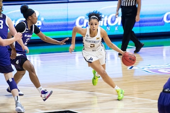 12 de marzo de 2021; Kansas City, Misuri, EE. UU.; la base de las West Virginia Mountaineers, Kysre Gondrezick (derecha), avanza hacia la canasta ante la base de las Kansas State Wildcats, Cymone Goodrich (izquierda), durante la segunda mitad en el Municipal Auditorium. Crédito obligatorio: Amy Kontras-USA TODAY Sports.