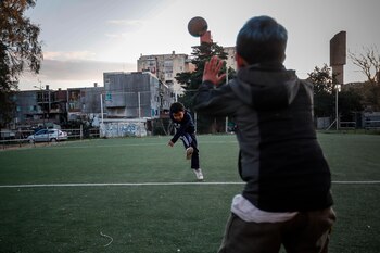 Dos niños juegan al fútbol,