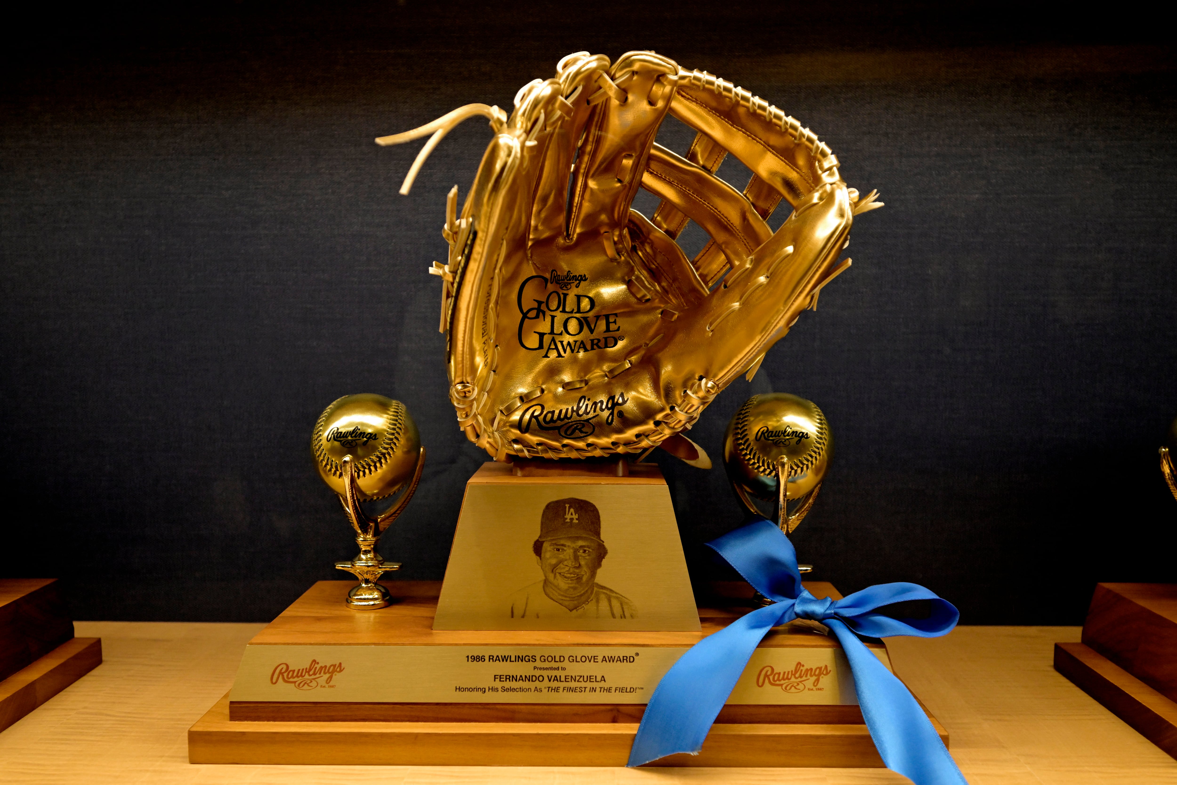 Oct 24, 2024; Los Angeles, CA, USA; A blue ribbon it tied to the Rawlings Gold Glove that was awarded to the late Los Angeles Dodgers pitcher Fernando Valenzuela in a display case at Dodger Stadium. Mandatory Credit: Jayne Kamin-Oncea-Imagn Images