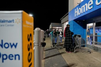 Shoppers wait for the doors