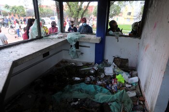 People look at a vandalized