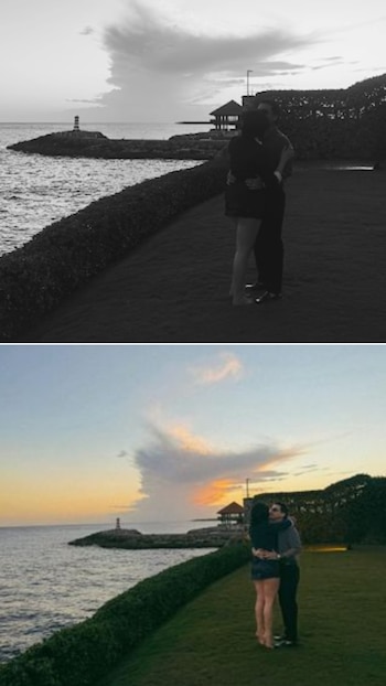 Imagen doble de Christian Nodal y Ángela Aguilar abrazándose en un césped junto al mar, con un faro en la distancia. Arriba en blanco y negro, abajo a color durante un atardecer