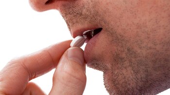 Man is going to take a pill